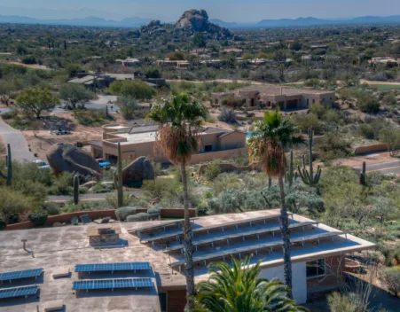 Aerial view of a Phoenix, Arizona home with solar panels on a flat roof