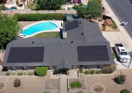 Aerial view of a Tempe, Arizona home with rooftop solar and a backyard pool